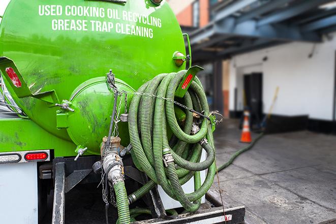 grease trap pumping truck in action in Broomall